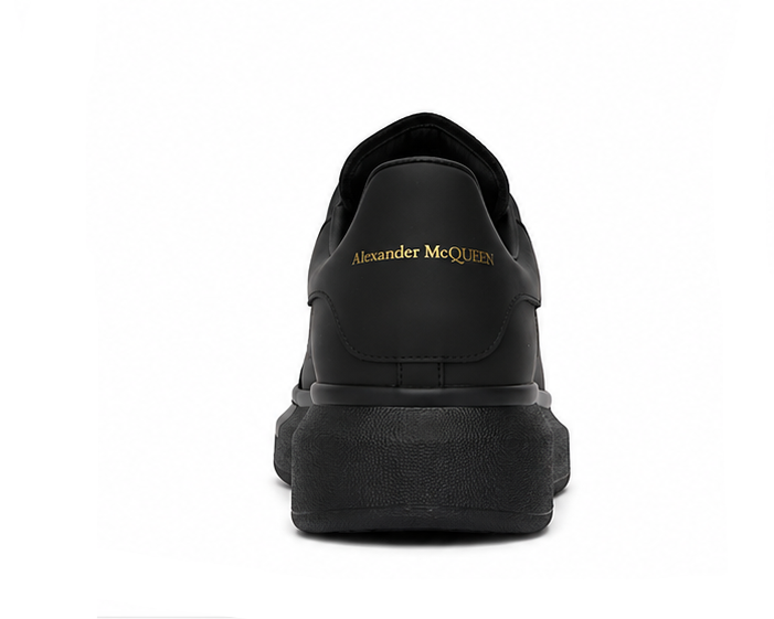 Alexander McQueen black sneaker rear view on white background